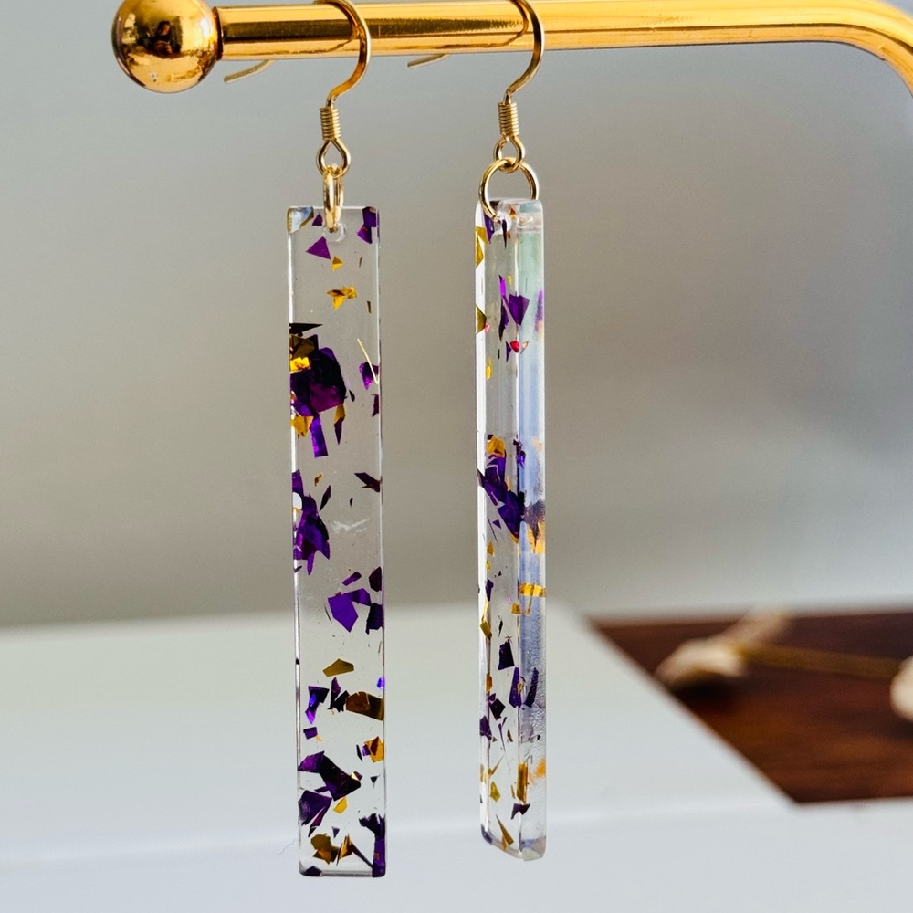 Clear resin long bar with purple and gold flakes , surgical steel hooks